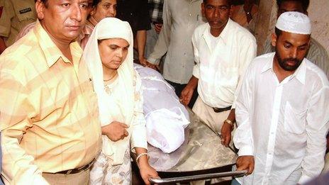 This file photo taken on 18 June 2004 shows Shamima Kausar (second from left) collecting the body of her daughter Ishrat Jahan from a hospital in Ahmedabad