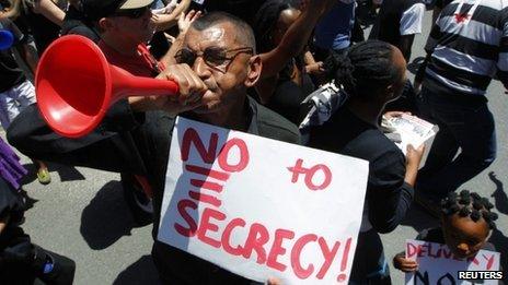 A demonstrator protests against the passing of the Protection of Information Bill outside parliament in Cape Town, 22 November 2011