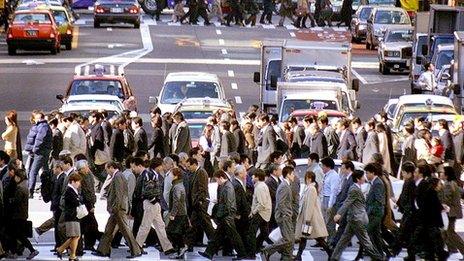 File image of residents and workers crossing the street in Tokyo