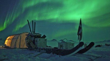 Aurora borealis over a tent of the Sirius Patrol in northern Greenland