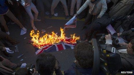 Protesters burn a British flag taken down from the British embassy in Tehran November 29, 2011.