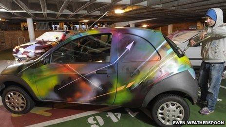 Car covered in graffiti. Photo by Ewen Weatherspoon