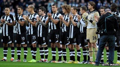 Newcastle United players join a minute's applause before the match against Chelsea