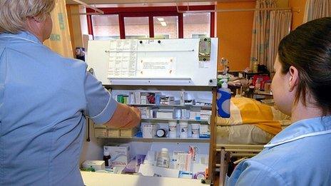 Nurses dispense drugs from a trolley