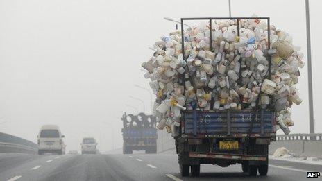 A truck carrying bottles drives in Beijing on 5 December 2011