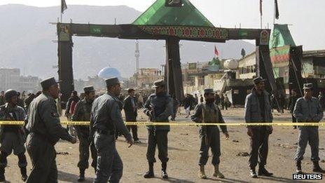 Afghan police keep watch after a suicide attack at a Shia Muslim gathering in Kabul