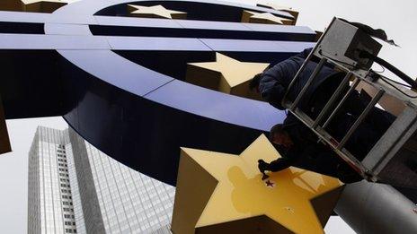 Worker clean the giant euro logo in front of the European Central Bank in Frankfurt. Photo: 6 December 2011