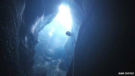 Abseiling into a moulin formed by rapid lake drainage