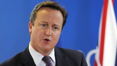 David Cameron speaks during a news conference in Brussels