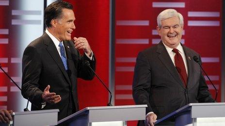 Former Massachusetts Gov. Mitt Romney and former Speaker of the House Newt Gingrich laugh during the GOP debate on the campus of Drake University on December 10, 2011 in Des Moines, Iowa