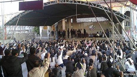 Villagers raise their hands as they gather for a protest in Wukan village of Lufeng, China's Guangdong province, 12 December 2011