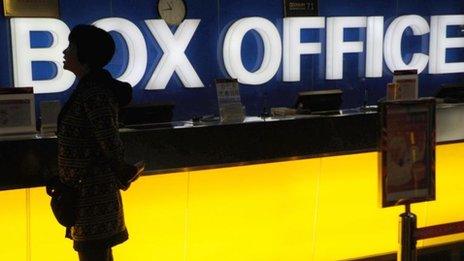 A Chinese woman checks what movies are playing at a cinema in Beijing, 8 November 2011