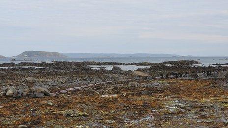 Long sea sewage outfall pipe with Herm and Sark in the background