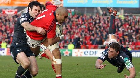 Stephen Jones tackles Munster wing Simon Zebo close to the Scarlets line`