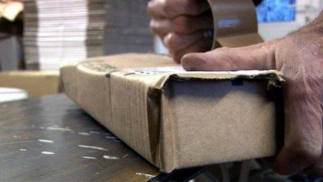 Man wrapping a parcel