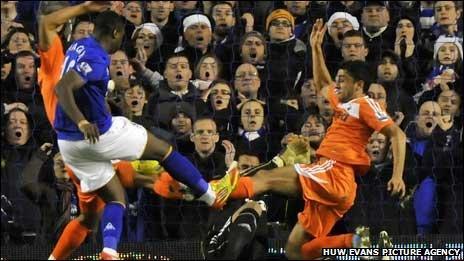 Neil Taylor stretches for the ball