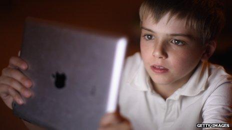 A young boy uses an iPad