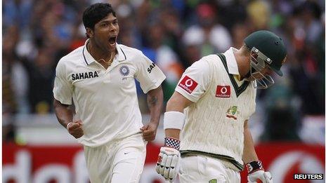 India"s Umesh Yadav (L) celebrates taking the wicket of Australia"s David Warner (R) during the first day of the first cricket test match, at the Melbourne Cricket Ground December 26, 2011