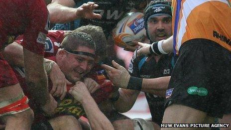 Scarlets prop Rhys Thomas celebrates his try against the Ospreys in the Pro12 west Wales derby