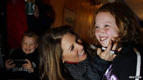 US Republican presidential candidate Michele Bachmann (centre) campaigns in Iowa on 23 December 2011