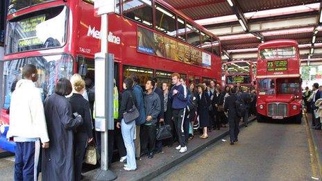 People queue for a bus