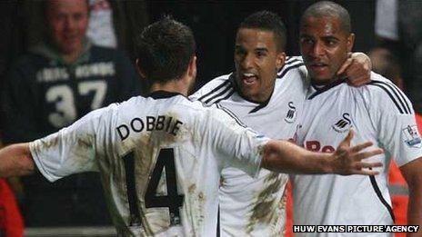 Scott Sinclair celebrates with Kemy Agustien and Stephen Dobbie