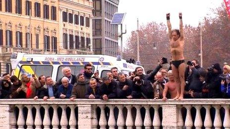 Man prepares to dive off a bridge