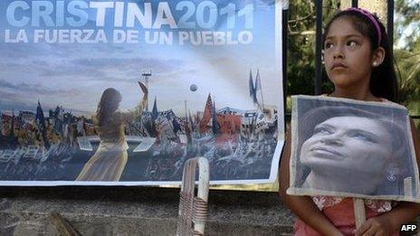 A girl holds a portrait of Argentine President Cristina Fernandez de Kirchner outside the Austral Hospital in Pilar, Buenos Aires, on 3 January 2012,