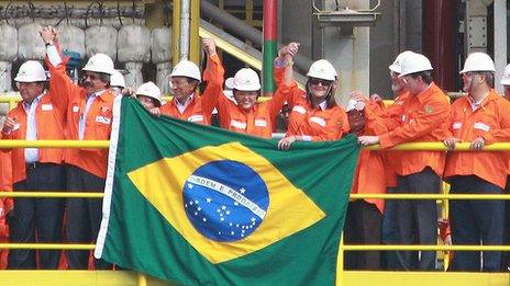 Brazilian President Dilma Rousseff joins workers to celebrate the construction of a new oil rig