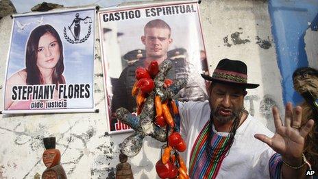 A shaman performs a ritual for the spiritual punishment of Joran van der Sloot, and for justice for Stephany Flores, in poster at left, as the murder trial gets underway (6 Jan 2012)