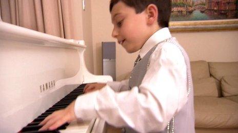 Eight year old boy playing piano