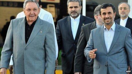 Cuban President Raul Castro (L) and Iranian President Mahmoud Ahmadinejad walk at Jose Marti airport, on 12 January before the latter's departure from Cuba