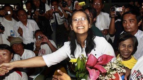 Nilar Thein, centre, an activist of the 88 Generation Students Group, shakes hands with one of her colleagues as she arrives at Rangoon airport after being released from Theyet prison Friday 13 January, 2012.