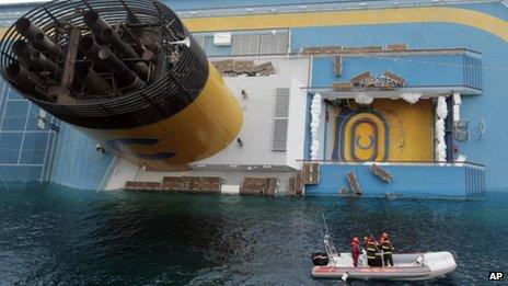 Italian divers approach the cruise ship Costa Concordia leaning on its side, 15 January