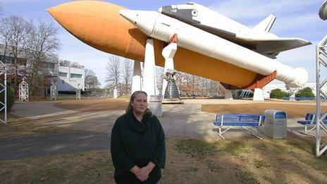 Karen Murphy in front of a shuttle replica in Huntsville, Alabama