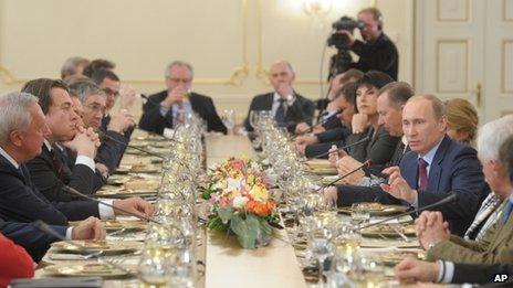 Russian Prime Minister Vladimir Putin (left) gestures during his meeting with editors near Moscow, 18 January