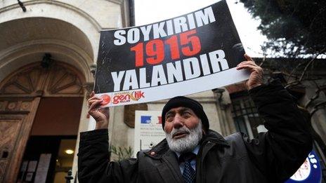 A Turkish man holds a placard reading "Genocide is a lie" in front of the French Consulate in Istanbul, 23 December 2011