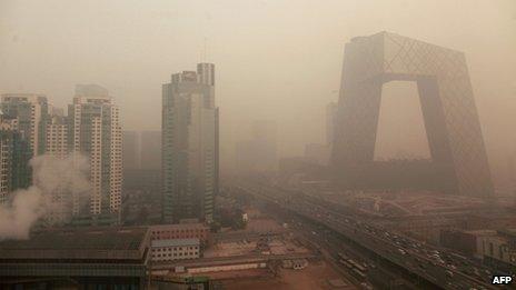 Heavy pollution surrounds the China Central Television (CCTV) headquarters building (R) in Beijing on January 18, 2012