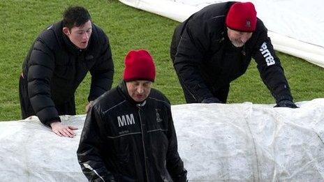 Inverness manager Terry Butcher helps get the pitch ready for his side's match agaisnt Hearts