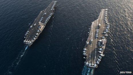 Handout photo of US aircraft carriers USS John C Stennis (left) and USS Abraham Lincoln in the Arabian Sea on 19 January 2012