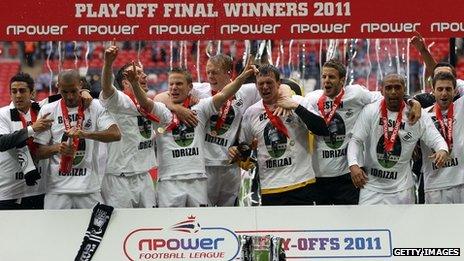 Swansea players celebrate after winning promotion to the Premier League