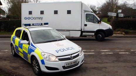 A police car next to the prison van that was ambushed