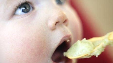 Baby being spoon fed