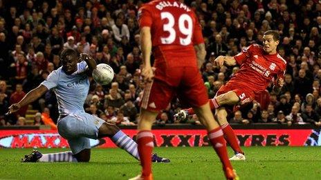 Daniel Agger's shot hits Micah Richards' arm