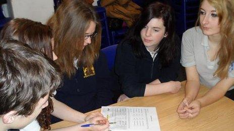 School pupils reading an information pack