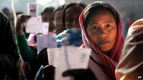 Women voters show their election cards as they stand queue to cast their votes in northeastern Indian state of Manipur (Jan. 28, 2012)