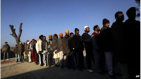 Indian voters wait in line to cast their ballots at a polling station near the India-Pakistan border for the Punjab State Assembly elections.