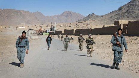 Afghan policemen walk ahead of the U.S. soldiers with the NATO- led International Security Assistance Force (ISAF) during a foot patrol in Kandahar, south of Kabul, Afghanistan, in this Jan. 7, 2012