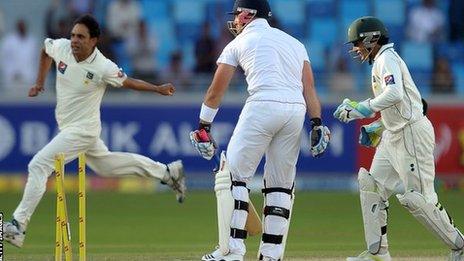 Matt Prior (centre) is bowled by Abdur Rehman (left)