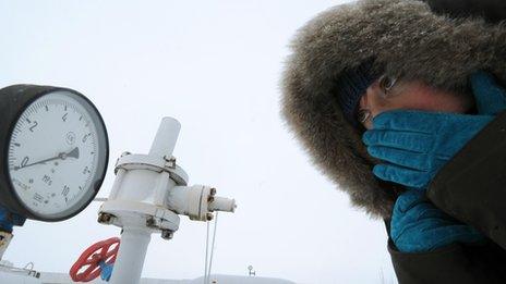 A women in Ukraine looks at a gas pressure monitor